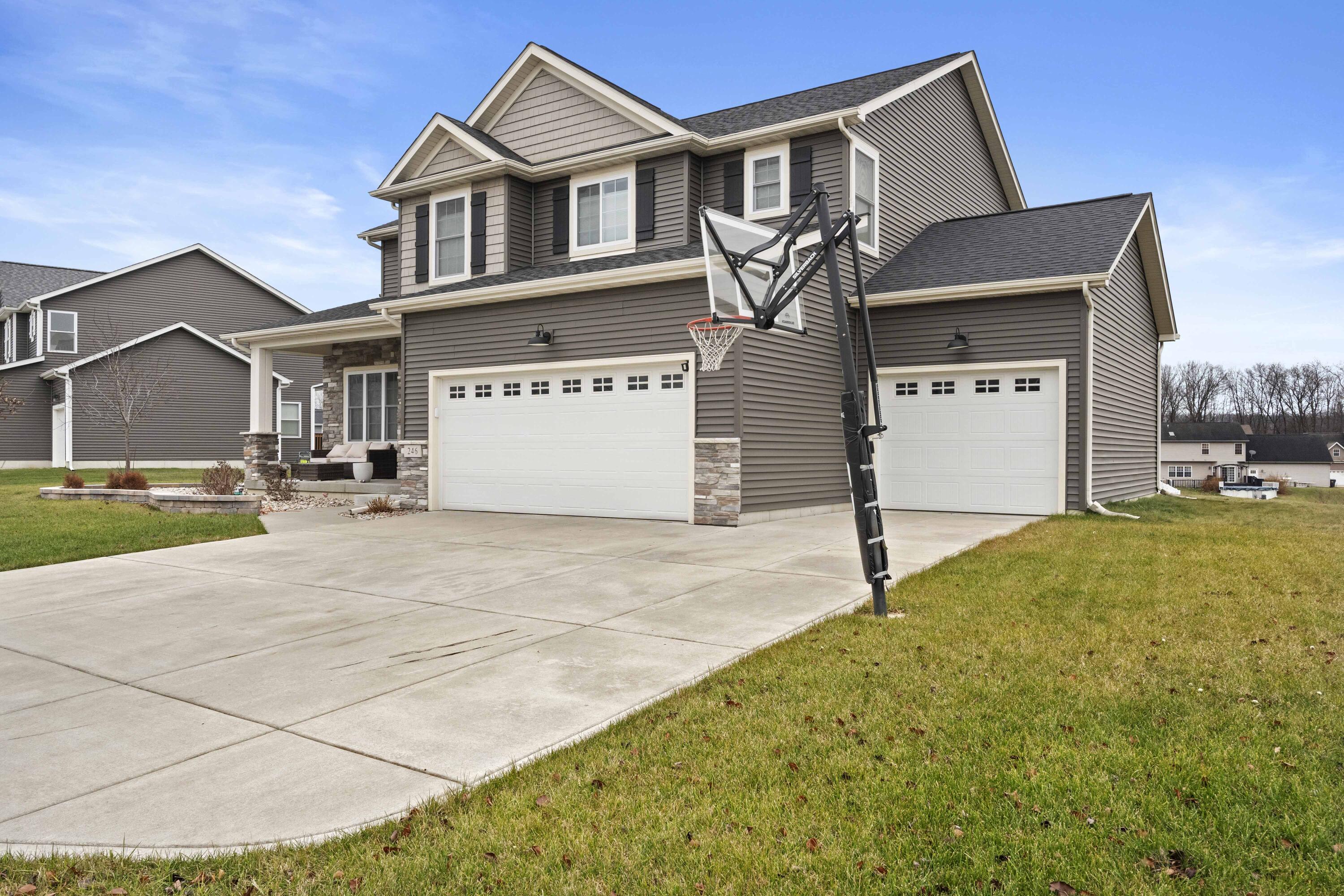 a front view of a house with a yard and garage