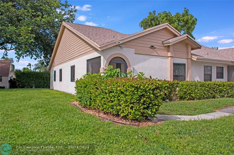 a front view of a house with a garden