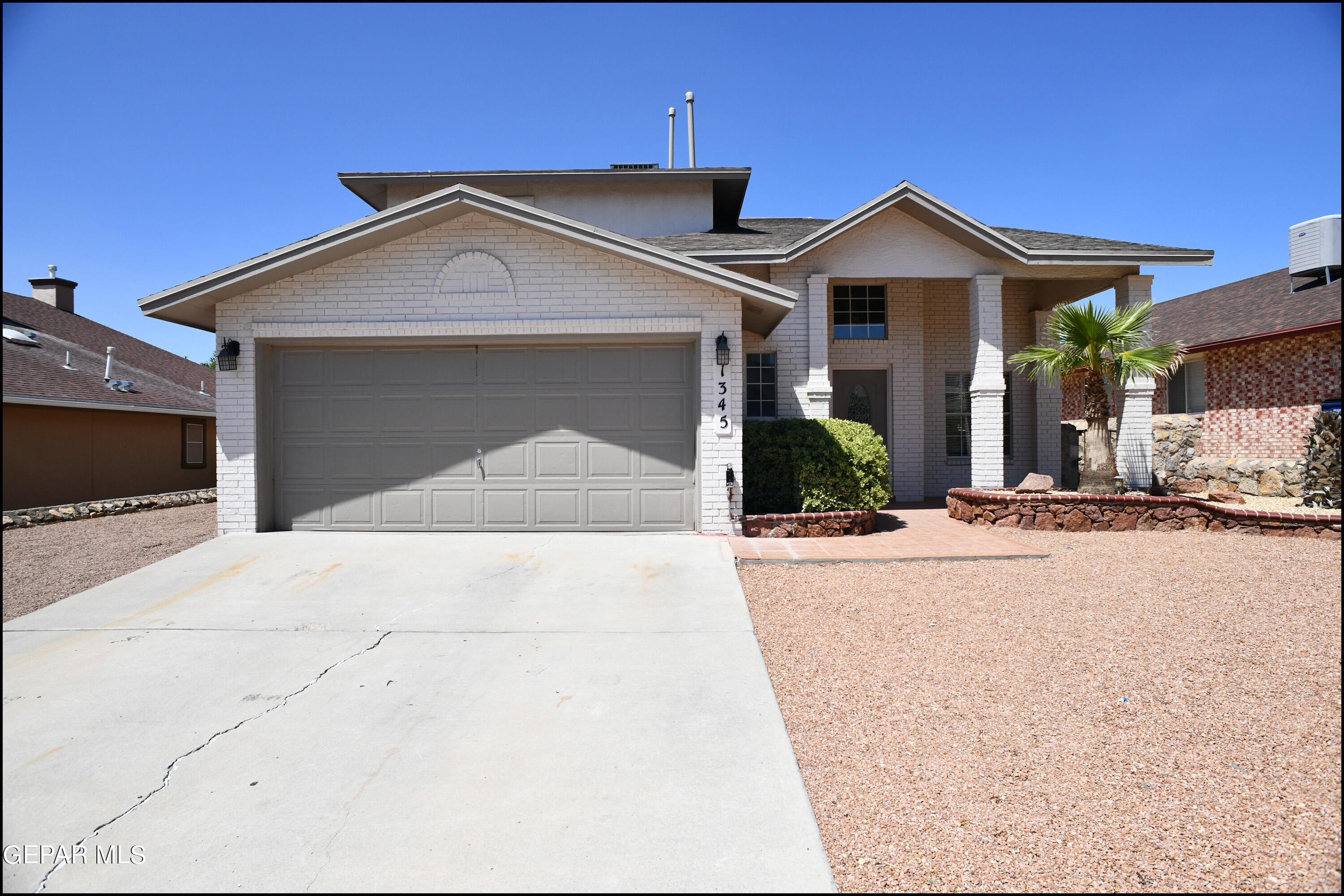 a view of a house with a yard and garage