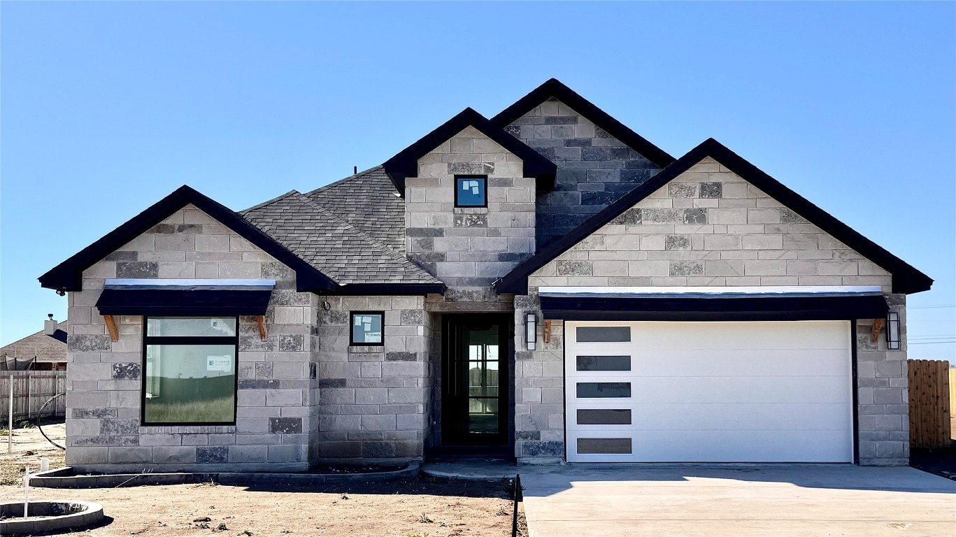 a front view of a house with garage