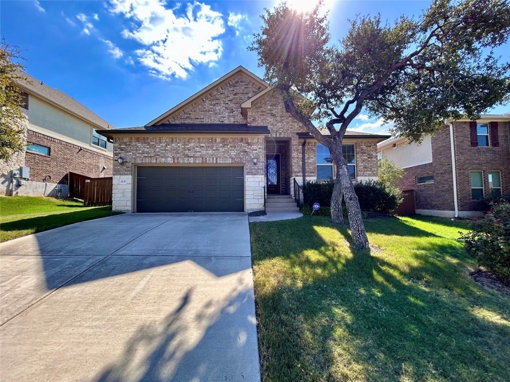 a front view of a house with a yard garage and outdoor seating