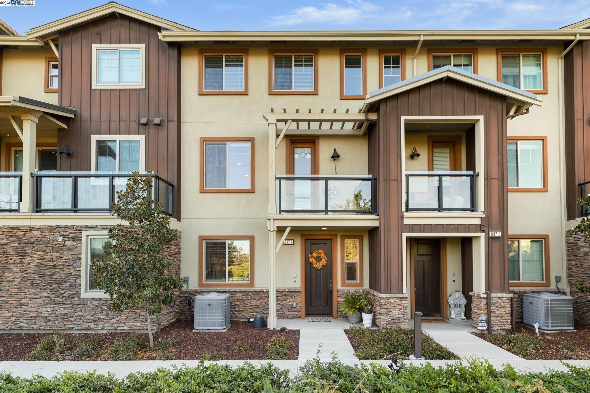 a front view of a residential apartment building with a yard