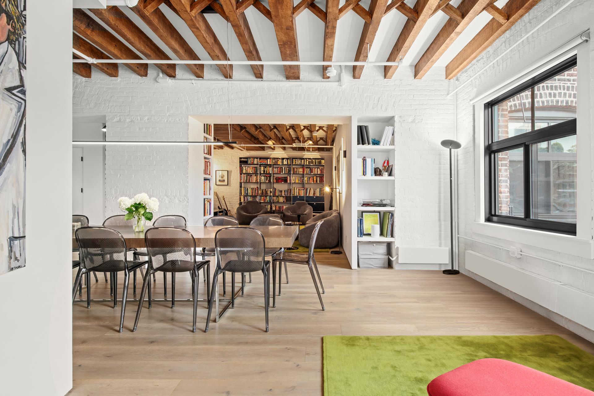 a dining room with furniture and wooden floor