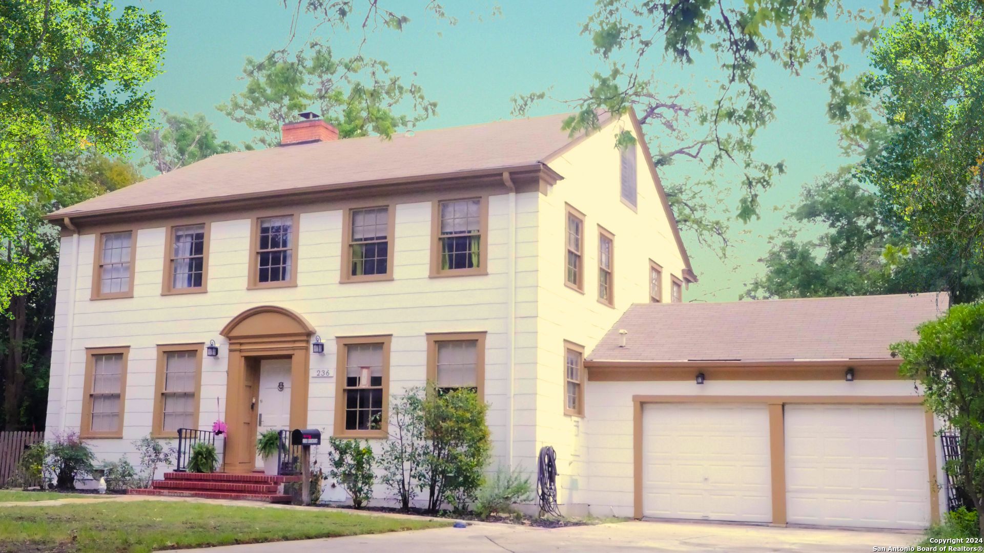 a front view of a house with garden