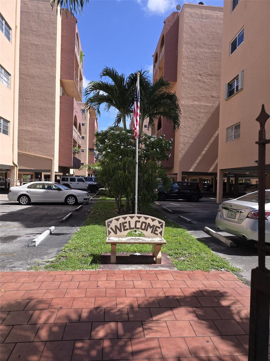 a street sign on a sidewalk next to a road