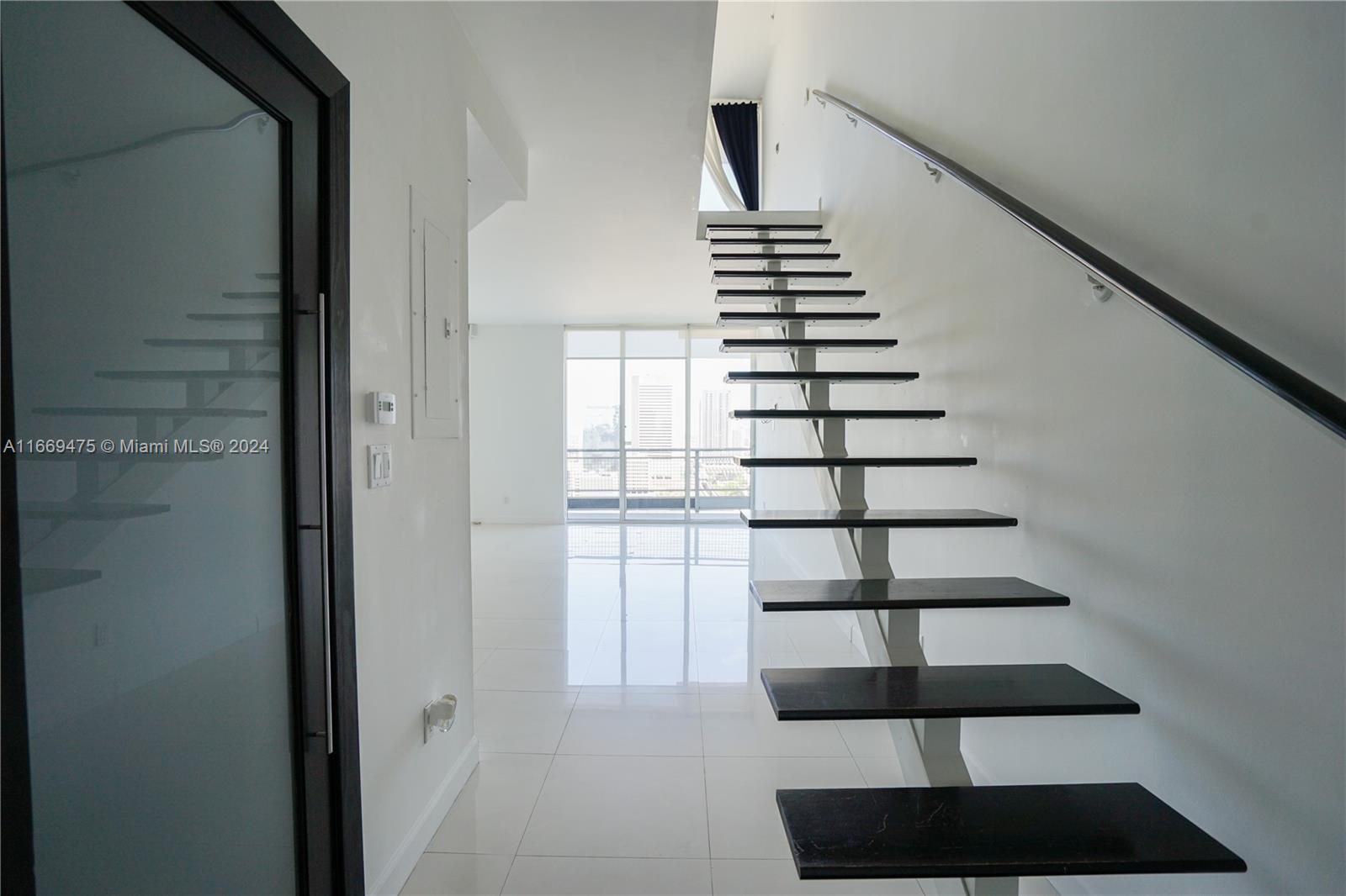 a view of entryway and hall with a front door