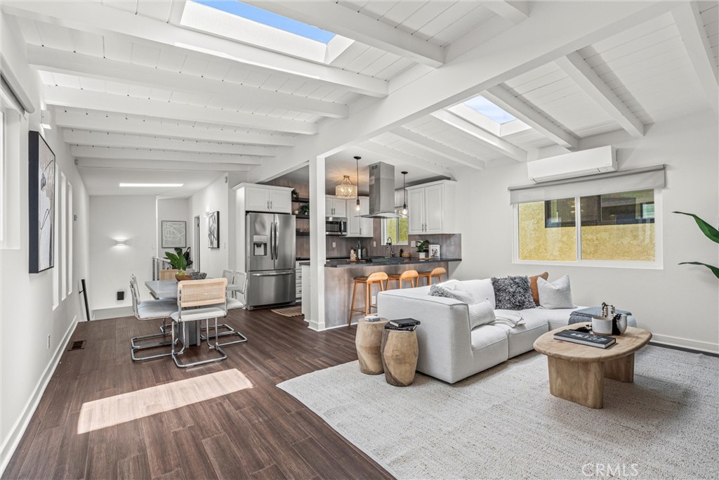 a living room with furniture a rug and a chandelier