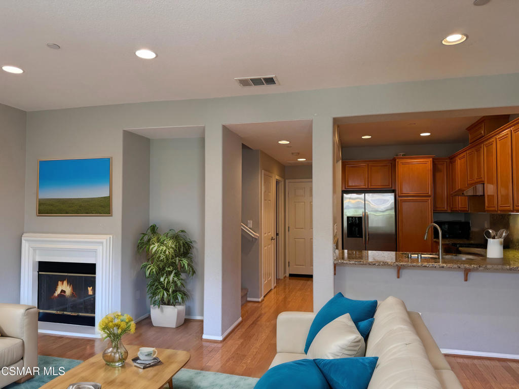 a living room with furniture potted plant and a fireplace