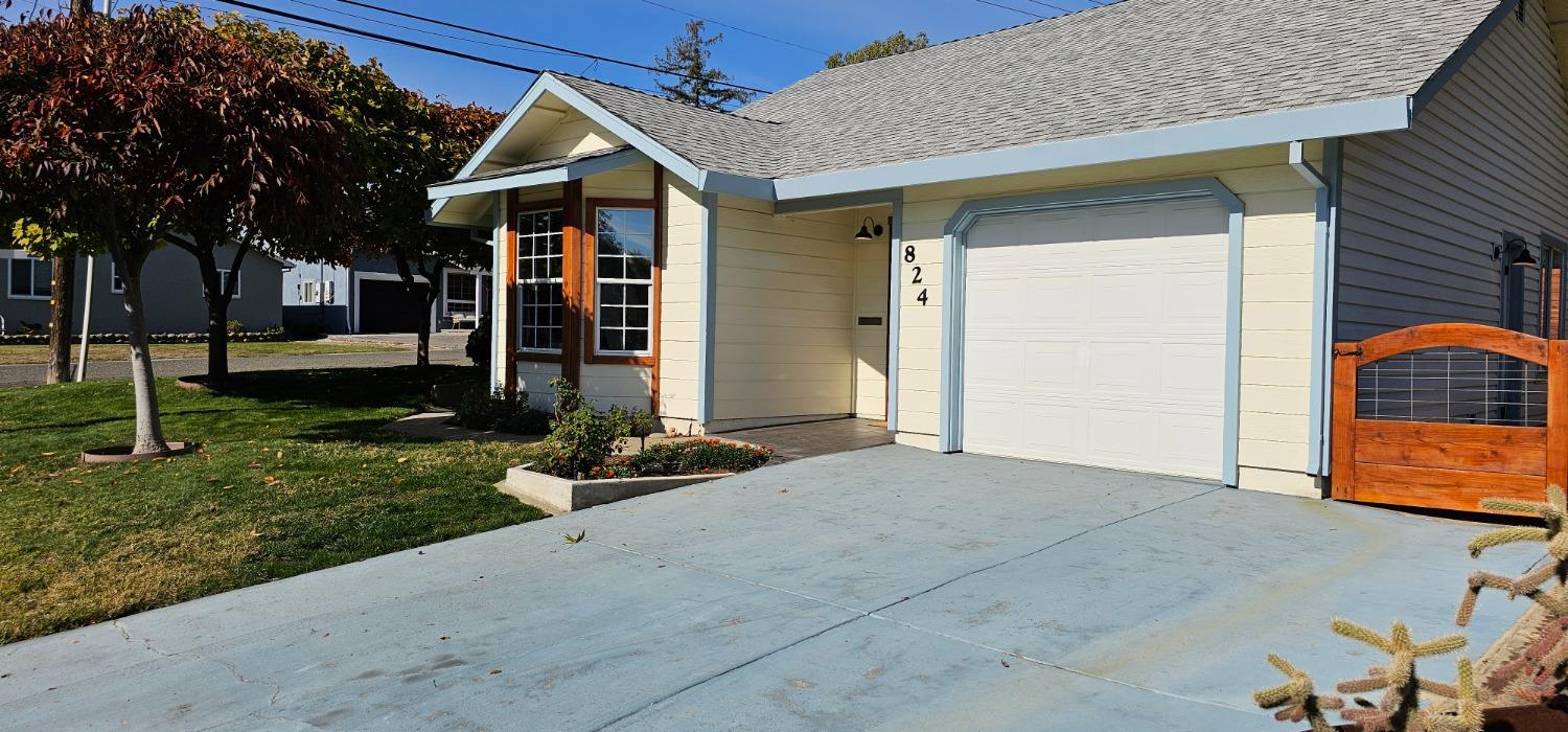 a front view of a house with garden