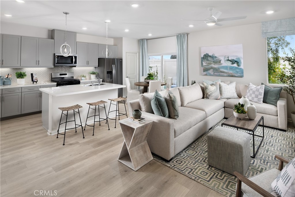 a living room with furniture and kitchen view