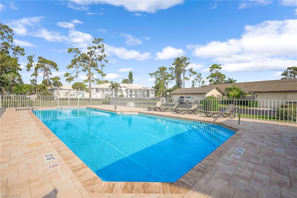 a view of a swimming pool with a lounge chair