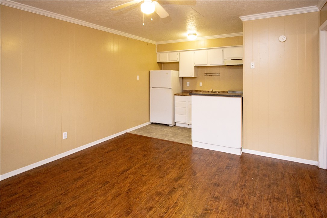 a view of a kitchen with a sink and a refrigerator