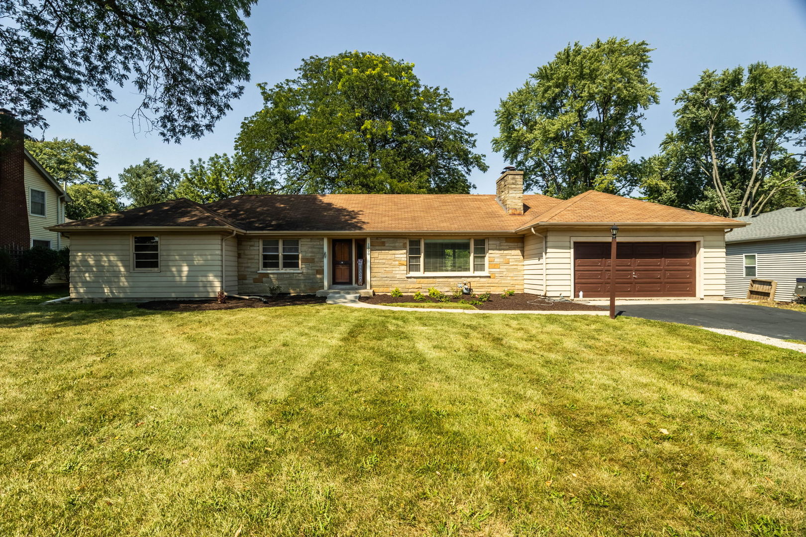 a front view of a house with a garden