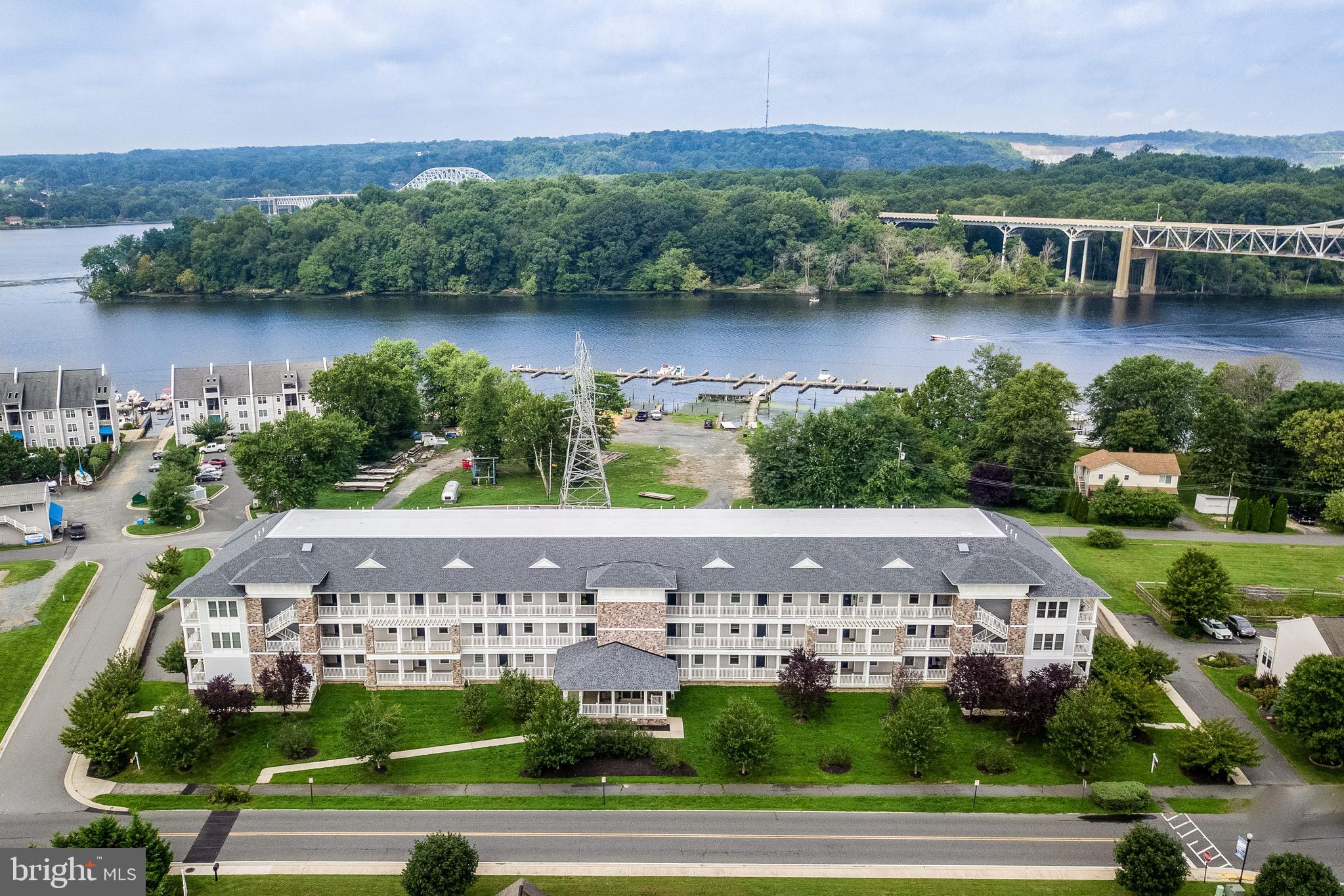 an aerial view of a house with a yard and lake view