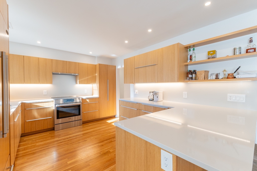 a kitchen with stainless steel appliances granite countertop a sink and a stove top oven