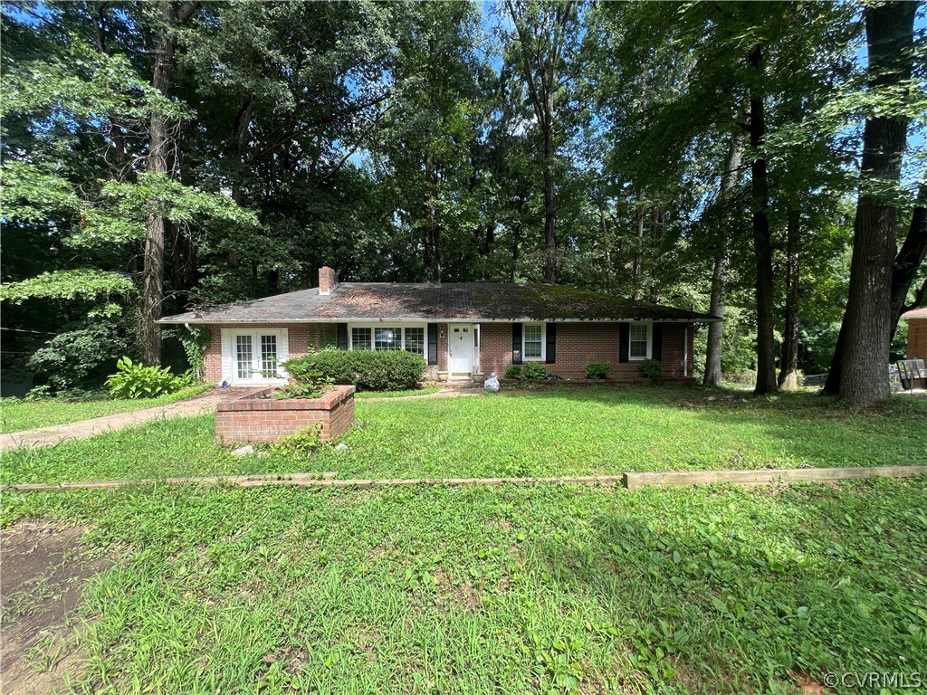 a front view of house with yard and green space