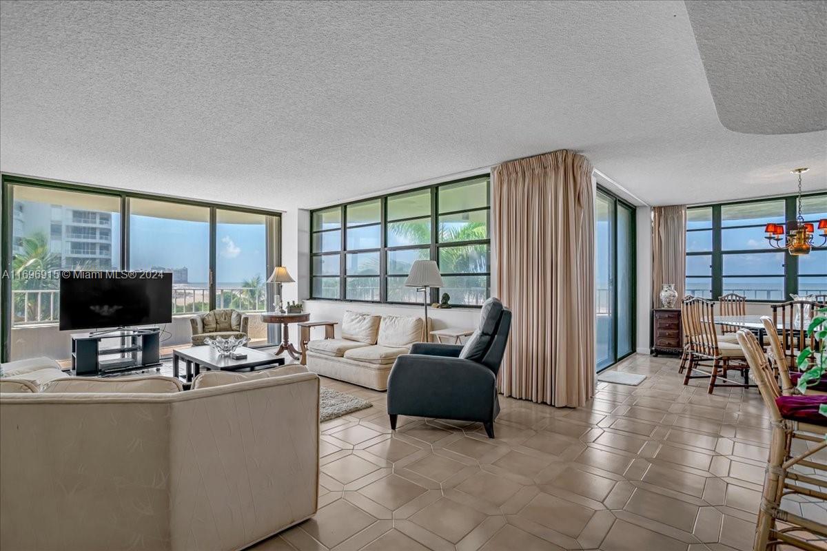 a living room with furniture and large windows