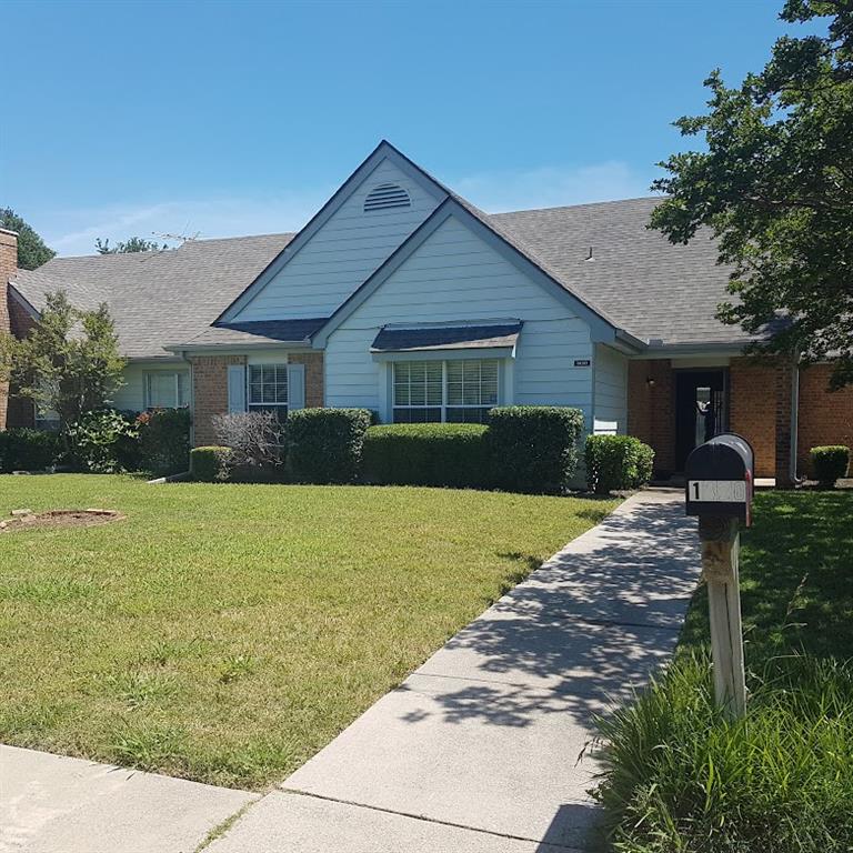 a front view of house with yard and trees