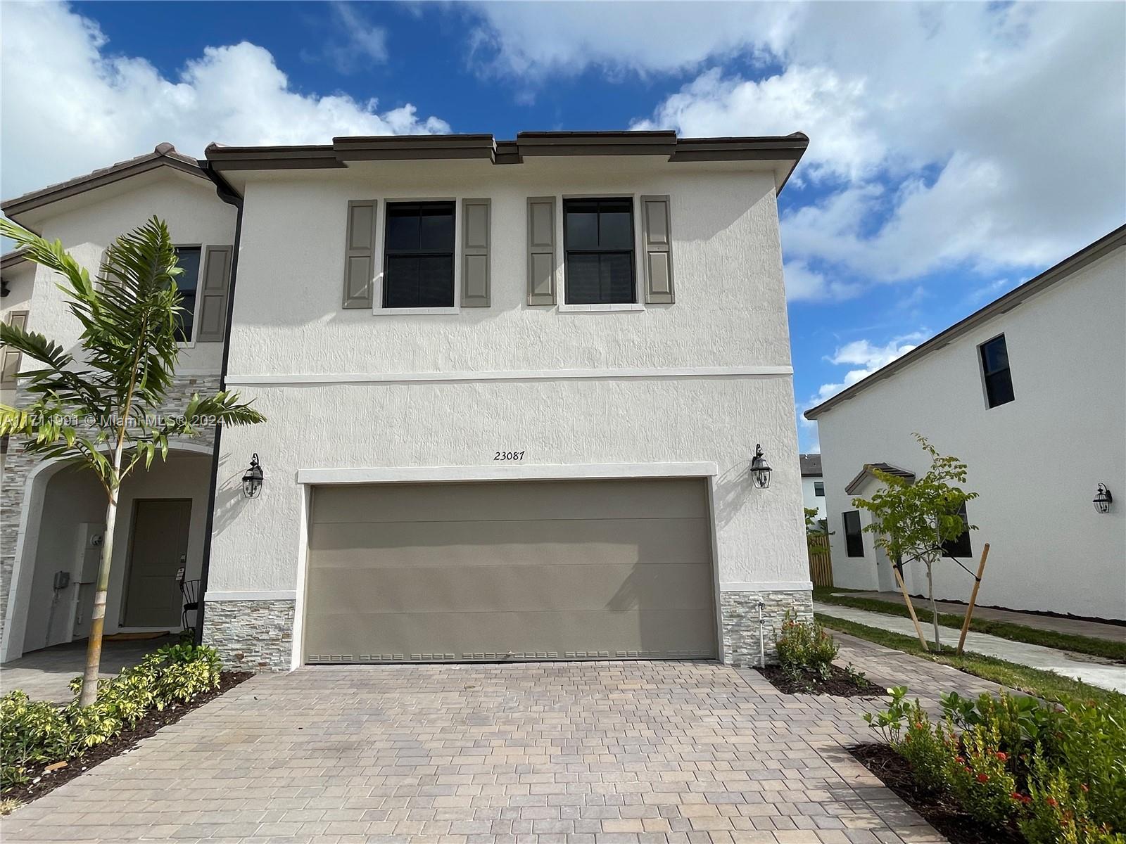 a front view of a house with a garage