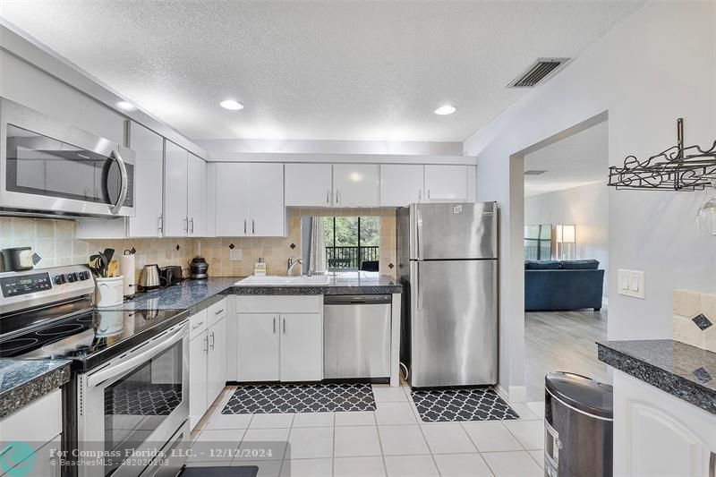 a kitchen with a refrigerator a sink and a stove