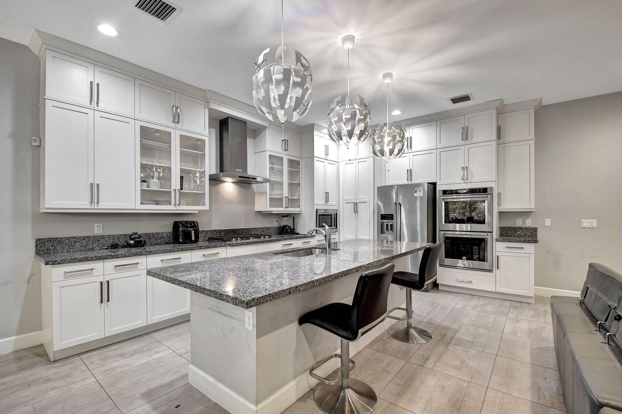 a kitchen with stainless steel appliances granite countertop a sink and cabinets