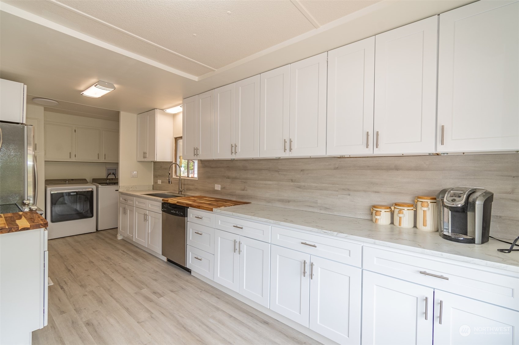 a kitchen with granite countertop white cabinets and white appliances