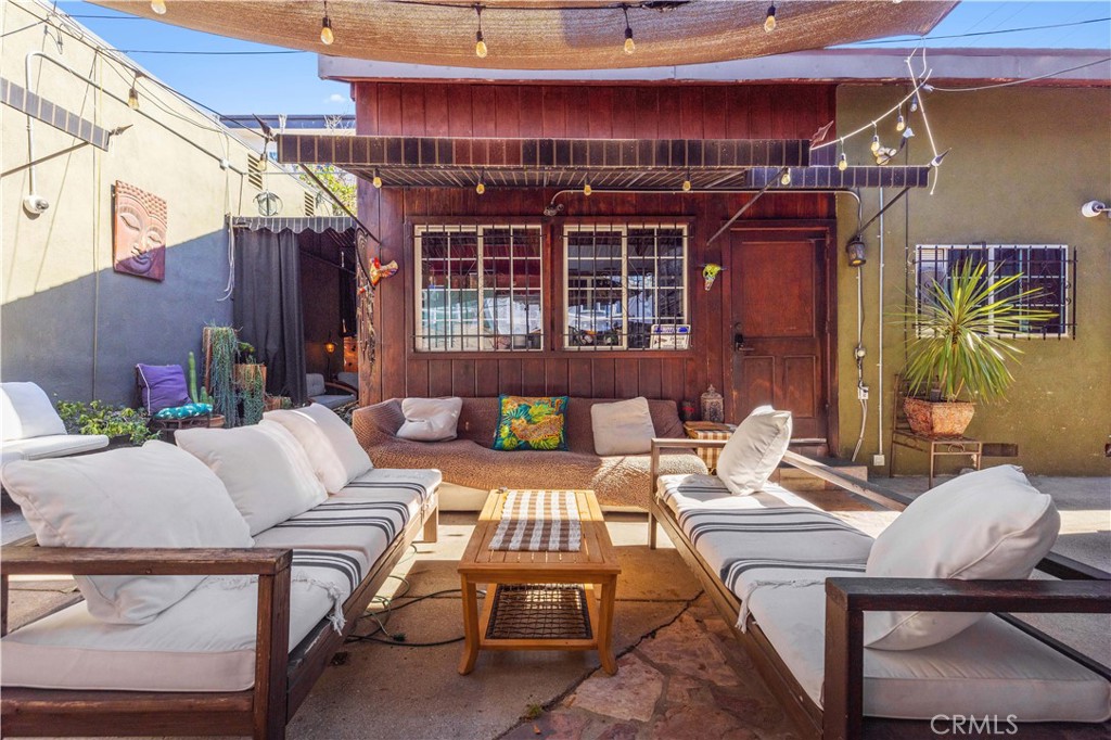 a view of a patio with couches and potted plants