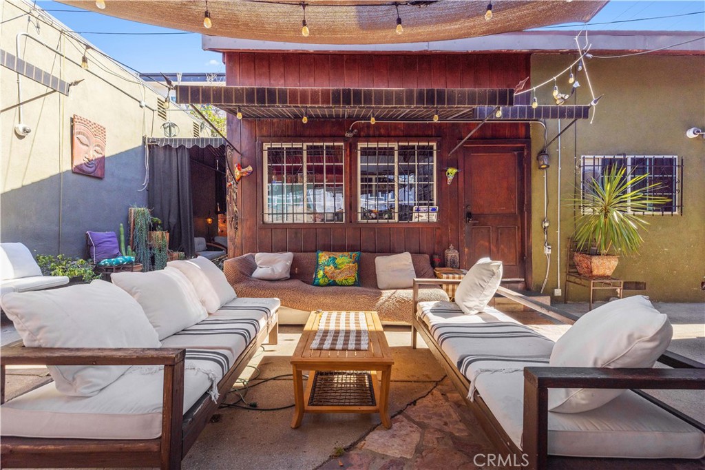 a view of a patio with couches and potted plants