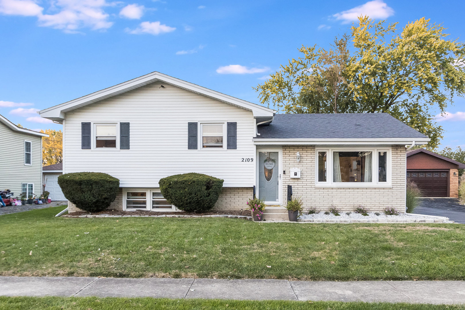 a front view of house with yard and green space