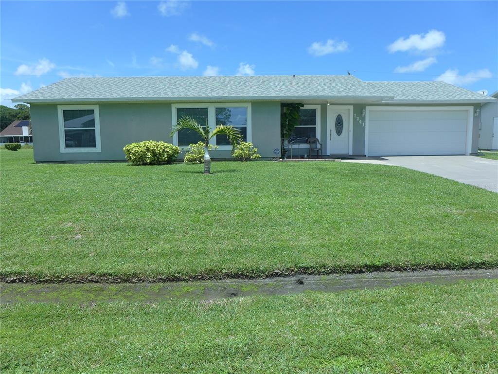 a front view of house with yard and green space