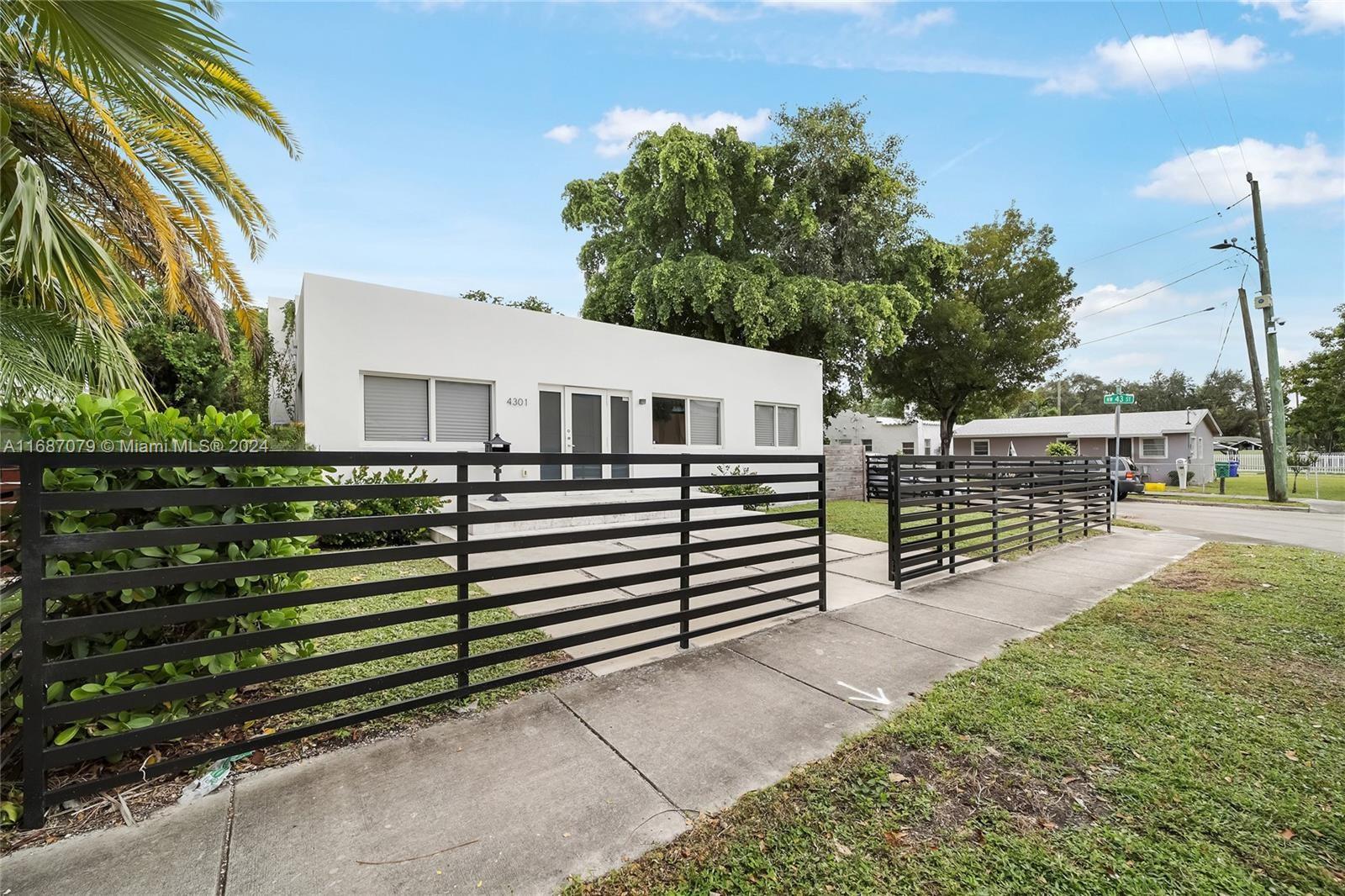 a view of a house with wooden fence