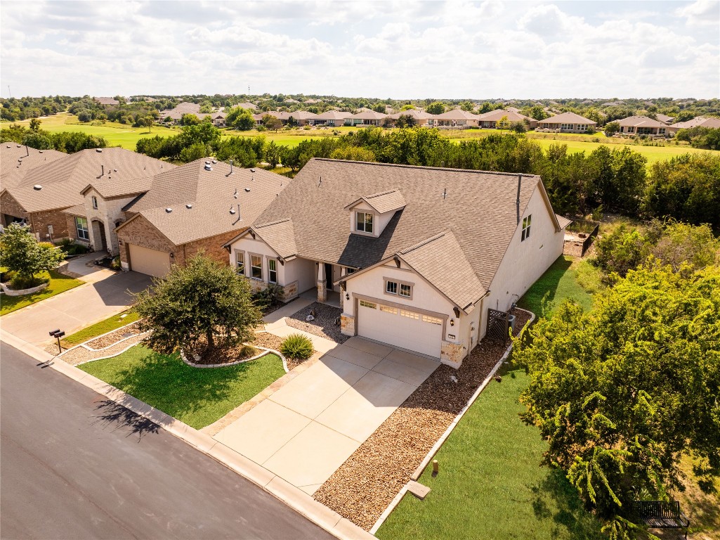 Aerial View of the Home and Gold Course in the Backyard with Open Lot Next Door with Garden, Green Space, and Benches