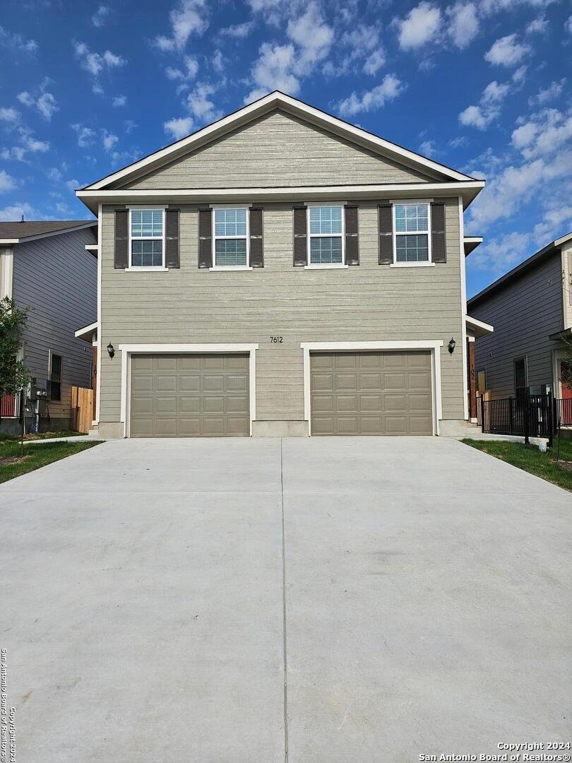 a front view of a house with garage