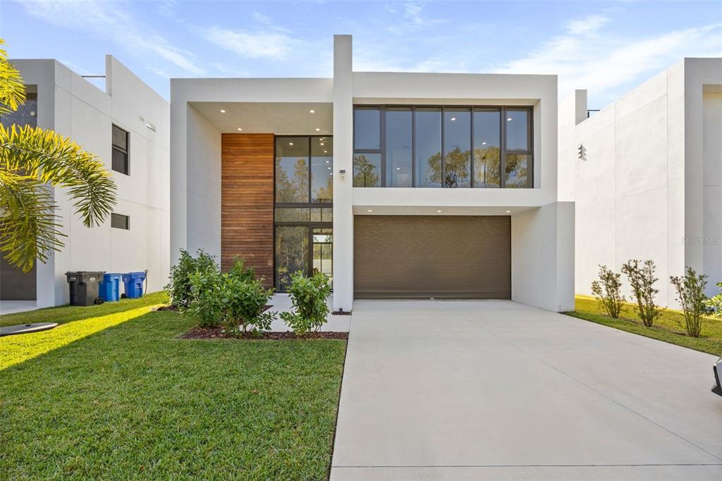 a front view of a house with a yard and garage