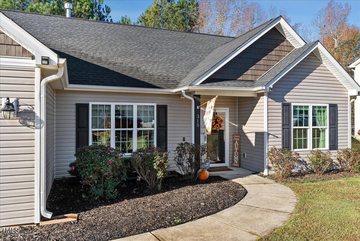 a front view of a house with garden