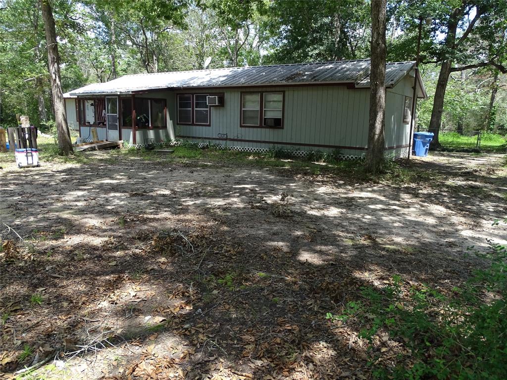 a backyard of a house with yard and tree