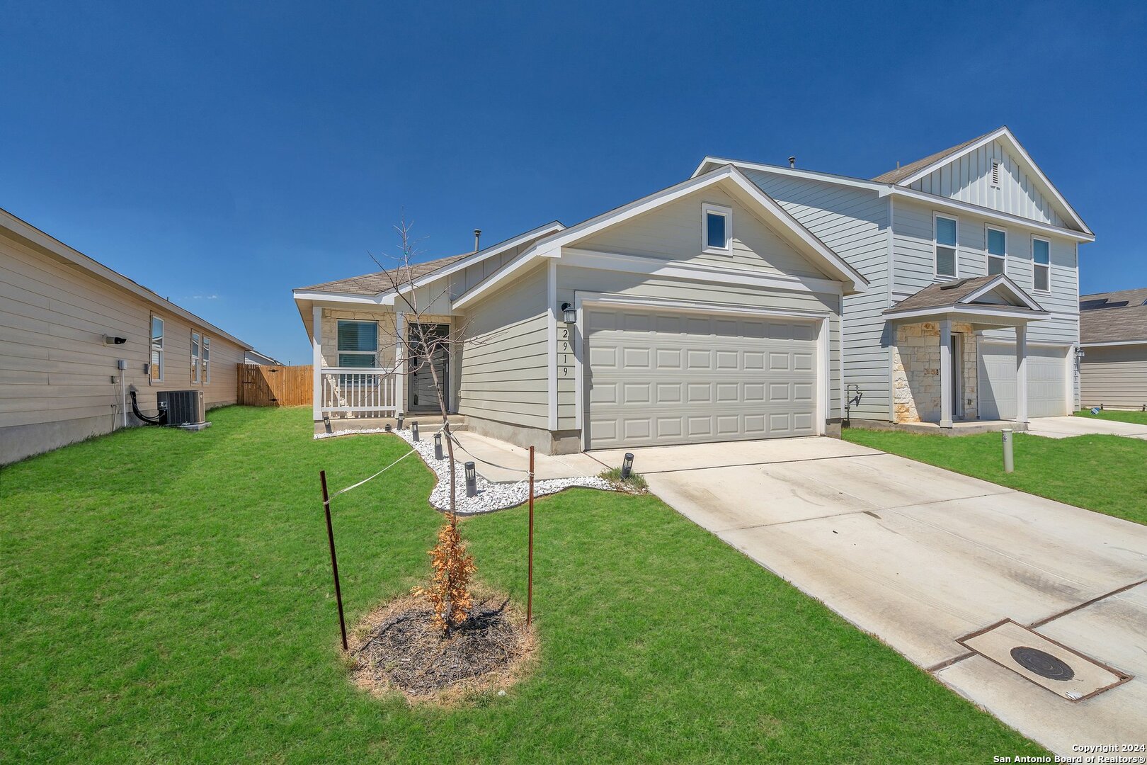 a front view of a house with a yard and garage