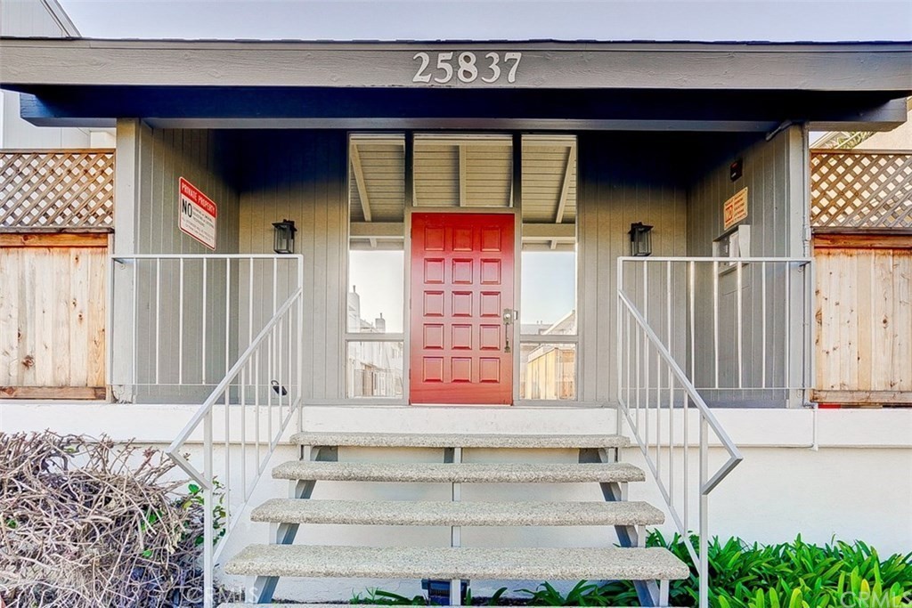 a front view of a house with entryway and windows