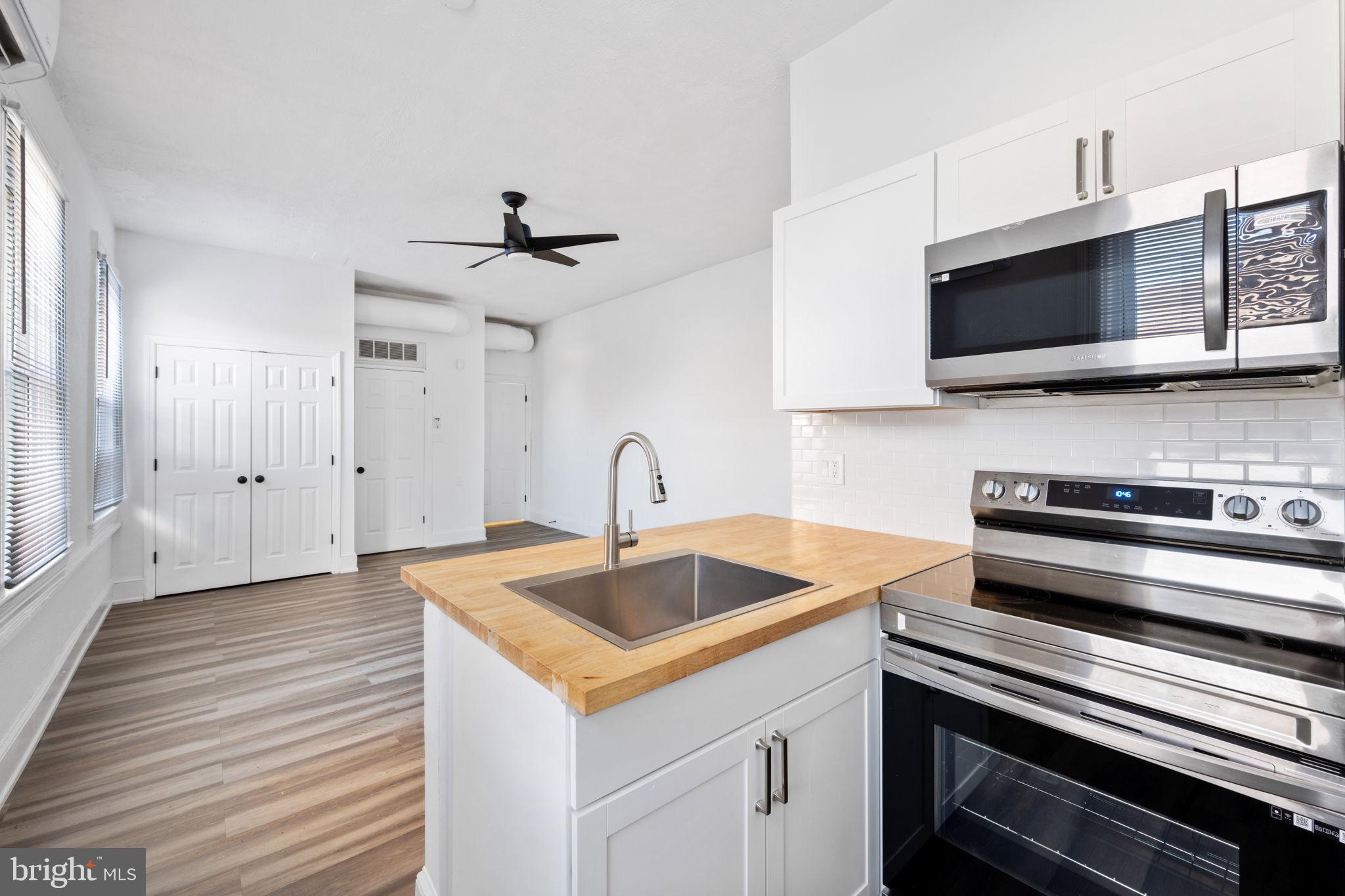 a kitchen with a sink and a microwave