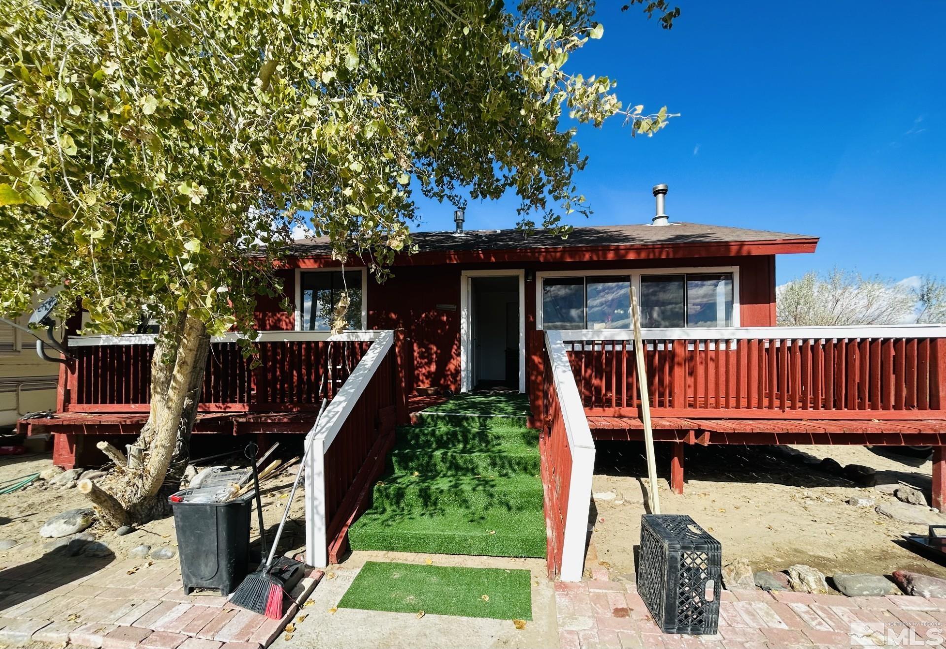 a view of a deck with furniture and yard