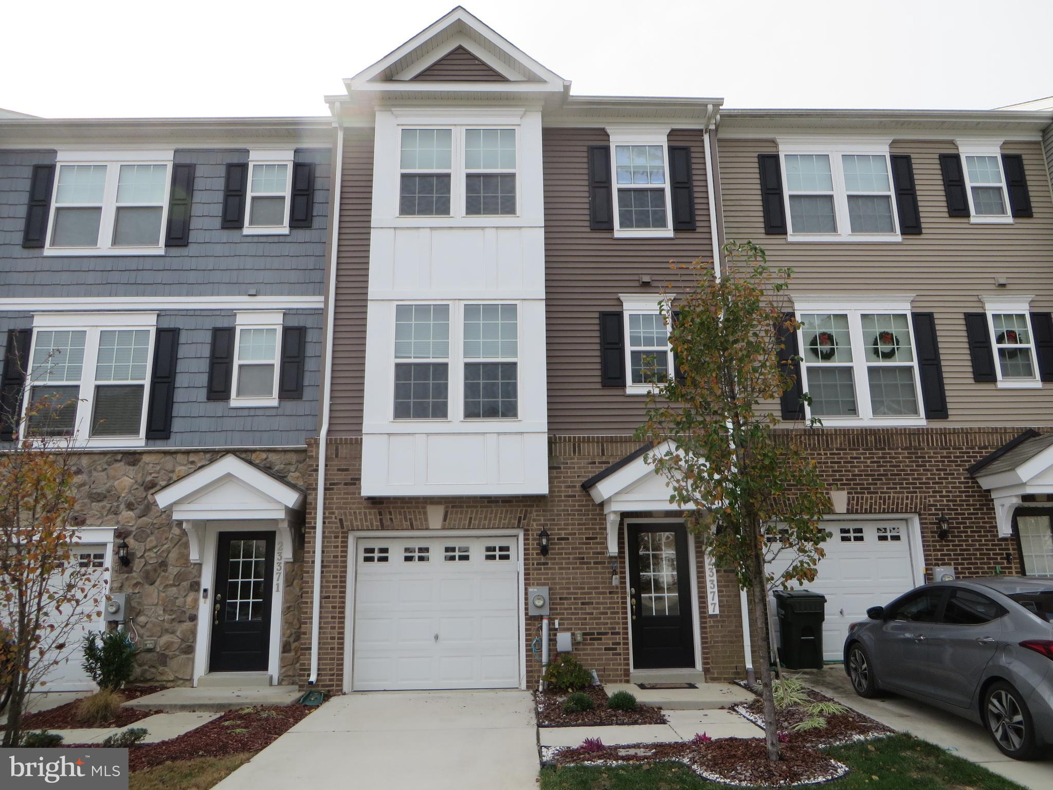 a front view of a residential apartment building with a yard