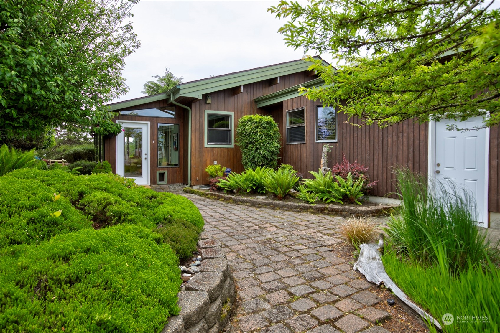 a front view of a house with garden