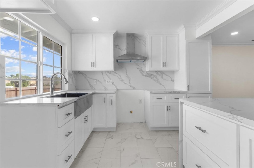 a kitchen with cabinets appliances a sink and a window