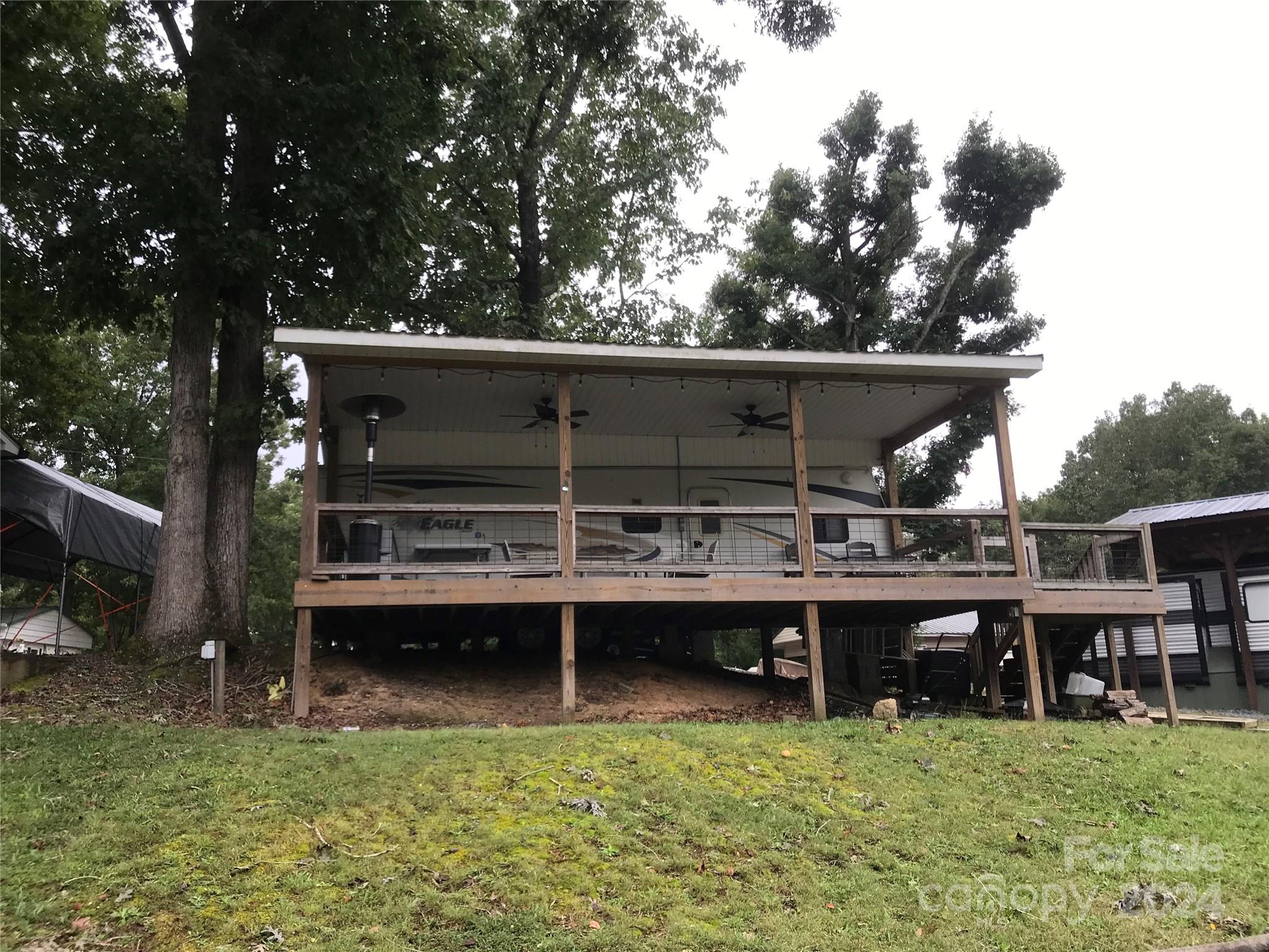 a view of a wooden deck and a yard