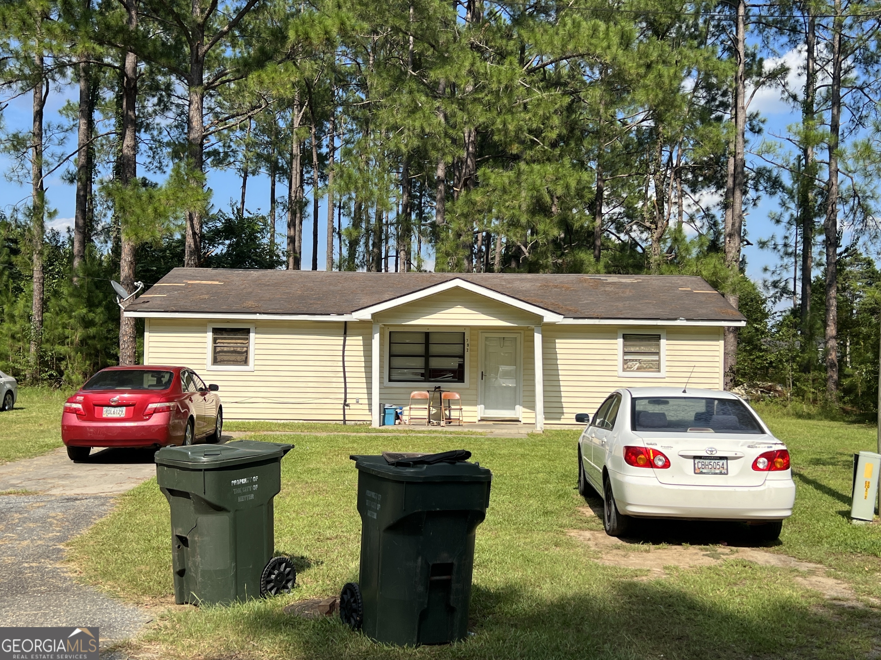 a front view of a house with a garden