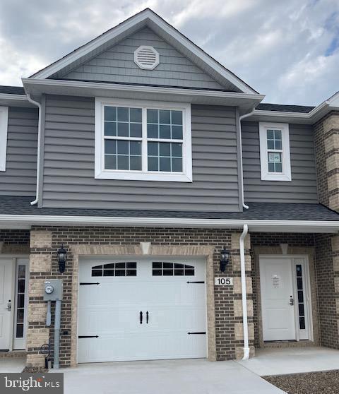 a front view of a house with a garage