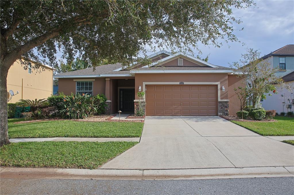 a front view of a house with a yard and garage