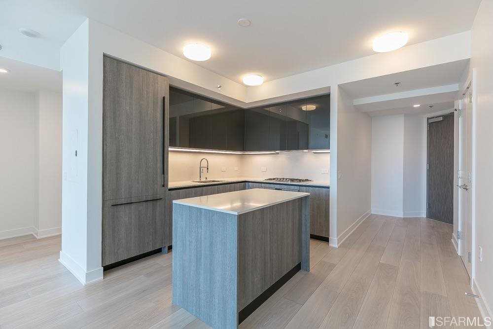 a kitchen with stainless steel appliances granite countertop a stove and a refrigerator