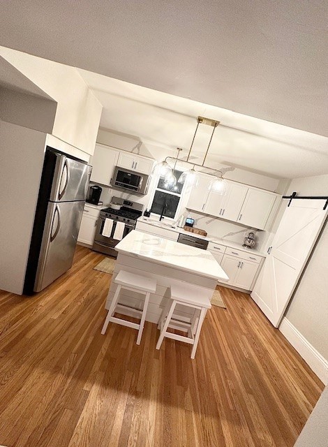 a view of a workspace with wooden floor