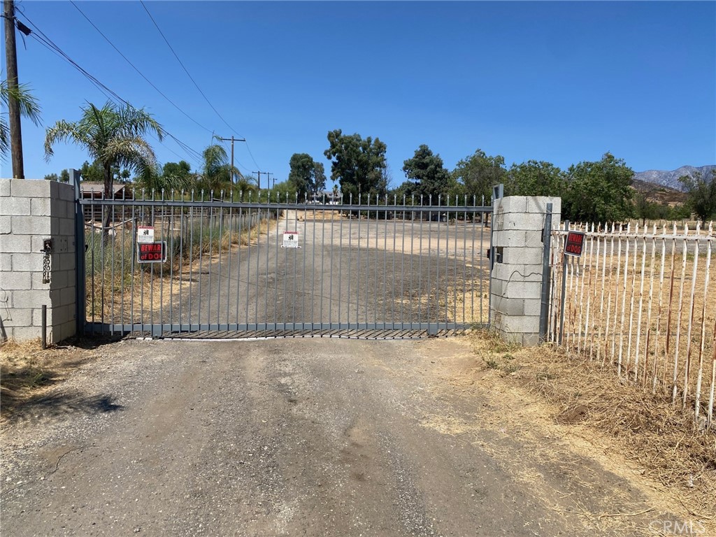 a view of a pathway with a wrought fence